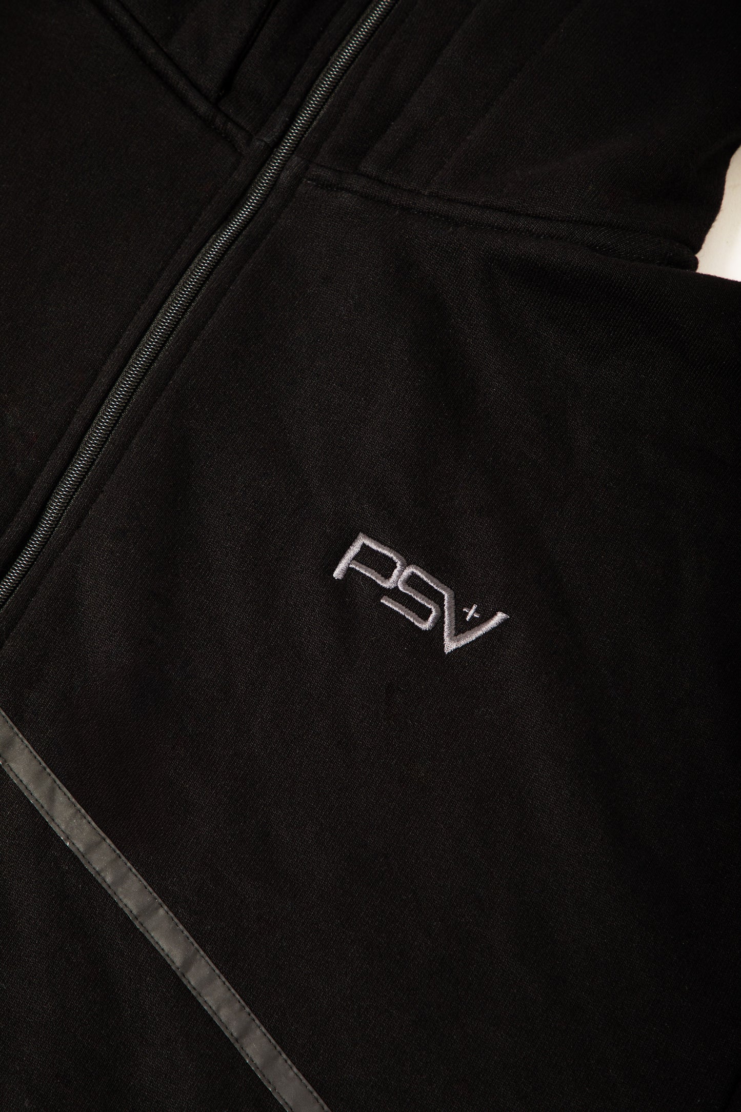 Black jacket with 'PSV' logo on a dark background