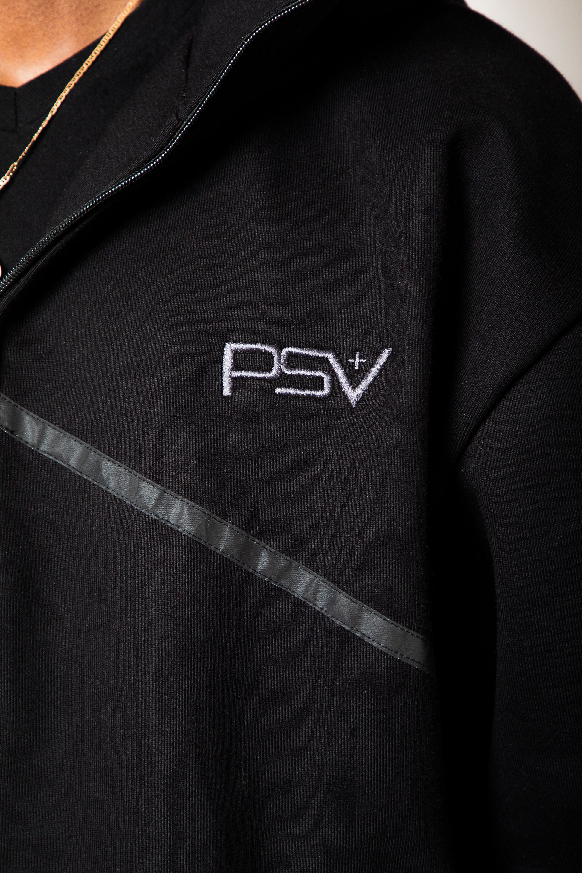 Black hoodie with 'PSV' logo on a neutral background